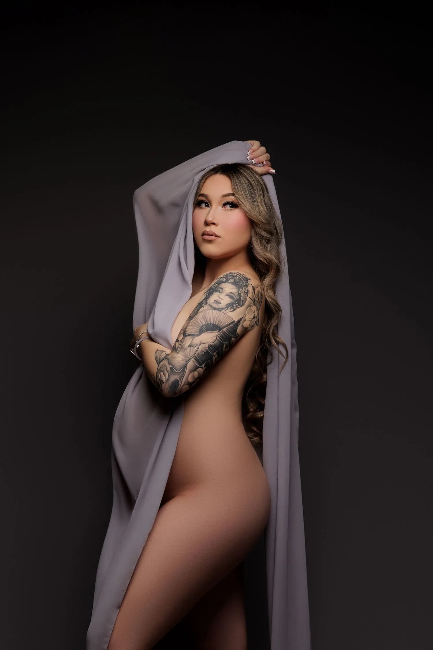 A gown from the studio wardrobe, styled and lit for a maternity portrait